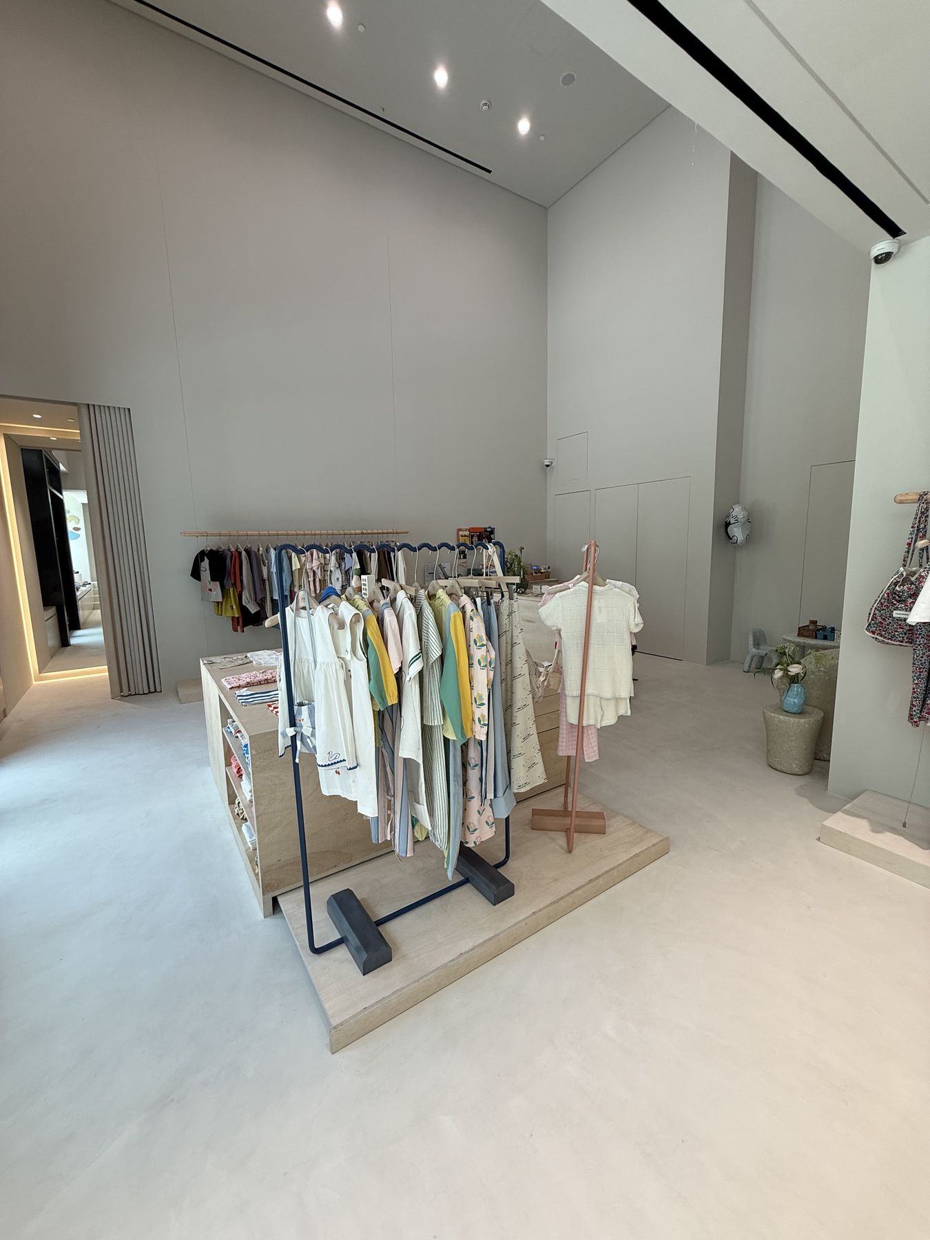 ODD kids concept store interior with oak display plinths and clothing rails, fit-out by Interprogetti, Qatar